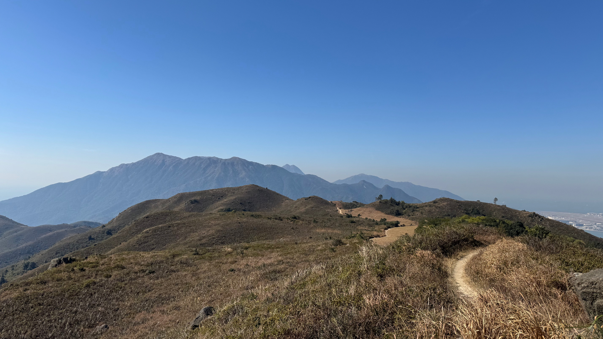 Hong Kong trail ridgeline with mountains in the distance